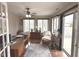 This office features wood floors, ceiling fan and lots of natural light from the windows and sliding glass doors at 7437 Vineyard Dr, Fishers, IN 46038