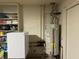 Utility room featuring a water heater, shelving and additional storage space at 7437 Vineyard Dr, Fishers, IN 46038