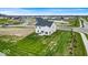 Aerial view showcases a home's backyard, community pond, and surrounding neighborhood homes at 7450 Leatherwood Dr, Indianapolis, IN 46259