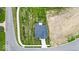 Birds-eye view of a property highlighting the roof, landscaping, sidewalk and surrounding vacant lot at 7450 Leatherwood Dr, Indianapolis, IN 46259