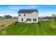 Exterior backyard view, featuring a well-maintained lawn, fence, and a small patio area at 7450 Leatherwood Dr, Indianapolis, IN 46259