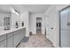 Bathroom with double sinks, large counter space, and tile floors at 7450 Leatherwood Dr, Indianapolis, IN 46259