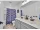 Bright bathroom featuring a double sink vanity, modern fixtures, and a shower-tub combo at 7450 Leatherwood Dr, Indianapolis, IN 46259