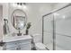 Modern bathroom with a sleek vanity, round mirror, and a frameless glass shower at 7450 Leatherwood Dr, Indianapolis, IN 46259