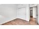 Cozy bedroom with hardwood floors, a closet, and an open doorway to another room at 7450 Leatherwood Dr, Indianapolis, IN 46259