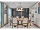 Dining room with wood table, fabric chairs, and a modern light fixture at 7450 Leatherwood Dr, Indianapolis, IN 46259