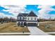 Two-story home with two car garage, white siding, black trim, and landscaping at 7450 Leatherwood Dr, Indianapolis, IN 46259
