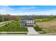 Beautiful two-story home with well-manicured lawn and a long driveway leading to a two-car garage at 7450 Leatherwood Dr, Indianapolis, IN 46259