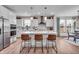 Open kitchen with large island, modern lighting, and stainless steel appliances at 7450 Leatherwood Dr, Indianapolis, IN 46259