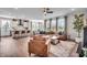 Open concept living room with leather furniture, wood floors, and plenty of natural light at 7450 Leatherwood Dr, Indianapolis, IN 46259