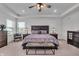 Comfortable bedroom with a king-size bed, a ceiling fan, and bedside tables with lamps at 7450 Leatherwood Dr, Indianapolis, IN 46259