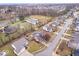 Wide aerial view of a neighborhood featuring large lots, mature trees, and a neighborhood pond at 8333 Hunters Meadow Ct, Indianapolis, IN 46259