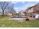 A backyard view with a pool covered for the off-season, as well as a small shed and patio at 8333 Hunters Meadow Ct, Indianapolis, IN 46259