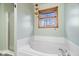 This bright bathroom features a glass enclosed shower and relaxing soaking tub under a window at 8333 Hunters Meadow Ct, Indianapolis, IN 46259