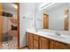 Bathroom features a double sink vanity, a shower-tub combo with a modern shower curtain, and a terrazzo-style floor at 8333 Hunters Meadow Ct, Indianapolis, IN 46259