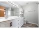 Bathroom featuring a double sink vanity with modern fixtures, a large mirror, and wood-look floors at 8333 Hunters Meadow Ct, Indianapolis, IN 46259