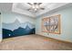 Comfortable bedroom features plush carpeting, mountain mural, and natural light streaming in through a large window at 8333 Hunters Meadow Ct, Indianapolis, IN 46259