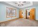 Bright bedroom with neutral carpet, window views, and easy access to bathroom and hallway at 8333 Hunters Meadow Ct, Indianapolis, IN 46259