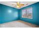 A cozy bedroom with bright blue walls, carpet and a window that provides plenty of natural light at 8333 Hunters Meadow Ct, Indianapolis, IN 46259