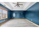This spacious bedroom features modern vinyl floors, a tray ceiling with fan, and natural light from a window at 8333 Hunters Meadow Ct, Indianapolis, IN 46259