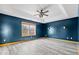 Spacious bedroom features modern flooring, tray ceiling with fan, and natural light from a large window at 8333 Hunters Meadow Ct, Indianapolis, IN 46259