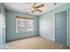 Bright bedroom with a ceiling fan, a window, and a neutral carpet at 8333 Hunters Meadow Ct, Indianapolis, IN 46259