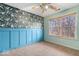 Charming bedroom features wainscoting, custom wallpaper, and lots of natural light at 8333 Hunters Meadow Ct, Indianapolis, IN 46259