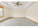 Bright, spacious bedroom with modern ceiling fan, tray ceiling, and hardwood flooring at 8333 Hunters Meadow Ct, Indianapolis, IN 46259