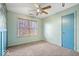 Comfortable carpeted bedroom with a ceiling fan and a bright blue door at 8333 Hunters Meadow Ct, Indianapolis, IN 46259