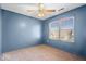 Bedroom features a ceiling fan, a window with blinds, and neutral carpet at 8333 Hunters Meadow Ct, Indianapolis, IN 46259