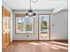 Dining area featuring new floors, updated light fixture and door leading to the backyard pool at 8333 Hunters Meadow Ct, Indianapolis, IN 46259