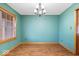 Bright dining room featuring wood floors, a chandelier and a large window at 8333 Hunters Meadow Ct, Indianapolis, IN 46259