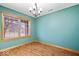 Bright dining room illuminated by a modern chandelier and natural light with beautiful hardwood floors at 8333 Hunters Meadow Ct, Indianapolis, IN 46259