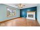 Bright living room with hardwood floors, fireplace, and a large window at 8333 Hunters Meadow Ct, Indianapolis, IN 46259