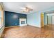 Cozy living room featuring hardwood floors, fireplace, and a ceiling fan at 8333 Hunters Meadow Ct, Indianapolis, IN 46259