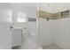 Modern bathroom featuring a tiled shower and bathtub with updated fixtures at 8615 El Rico Dr, Indianapolis, IN 46240