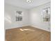 Bright bedroom with hardwood floors and natural light from two windows at 8615 El Rico Dr, Indianapolis, IN 46240
