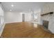 Spacious living room featuring hardwood floors, a stone fireplace, and ample natural light at 8615 El Rico Dr, Indianapolis, IN 46240