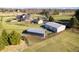 Aerial view of home and farm buildings with pastures and trees at 8810 E 200 S, Zionsville, IN 46077