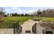 Expansive backyard with pergola, patio, fire pit, and scenic views of lush green space and perimeter fencing at 8810 E 200 S, Zionsville, IN 46077