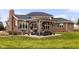 Backyard with pergola, patio and furniture set for entertaining, with a beautiful brick home in the background at 8810 E 200 S, Zionsville, IN 46077