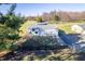 Aerial view of a barn with a metal roof, set among trees and greenery at 8810 E 200 S, Zionsville, IN 46077
