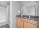 Bathroom featuring a vanity with granite countertop and a glass-enclosed shower at 8810 E 200 S, Zionsville, IN 46077