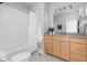 Bright bathroom featuring tile floors, granite countertop vanity, toilet, and shower tub combo at 8810 E 200 S, Zionsville, IN 46077