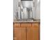 Modern bathroom with a granite countertop, wood cabinets, and stylish lighting at 8810 E 200 S, Zionsville, IN 46077