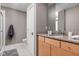 Well-lit bathroom boasts a wooden vanity with ample storage, granite countertop, and modern fixtures at 8810 E 200 S, Zionsville, IN 46077