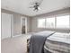 Spacious bedroom with a ceiling fan, large window, and soft carpeting offers comfort and natural light at 8810 E 200 S, Zionsville, IN 46077
