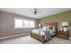 Cozy bedroom features a large window, wood bed frame, and neutral tones for a relaxing and inviting atmosphere at 8810 E 200 S, Zionsville, IN 46077