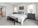 Bedroom with large bed, two side tables and a bench, plus windows with natural light at 8810 E 200 S, Zionsville, IN 46077