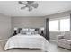 A cozy bedroom with a ceiling fan, window, and comfortable seating creates a relaxing and inviting atmosphere at 8810 E 200 S, Zionsville, IN 46077